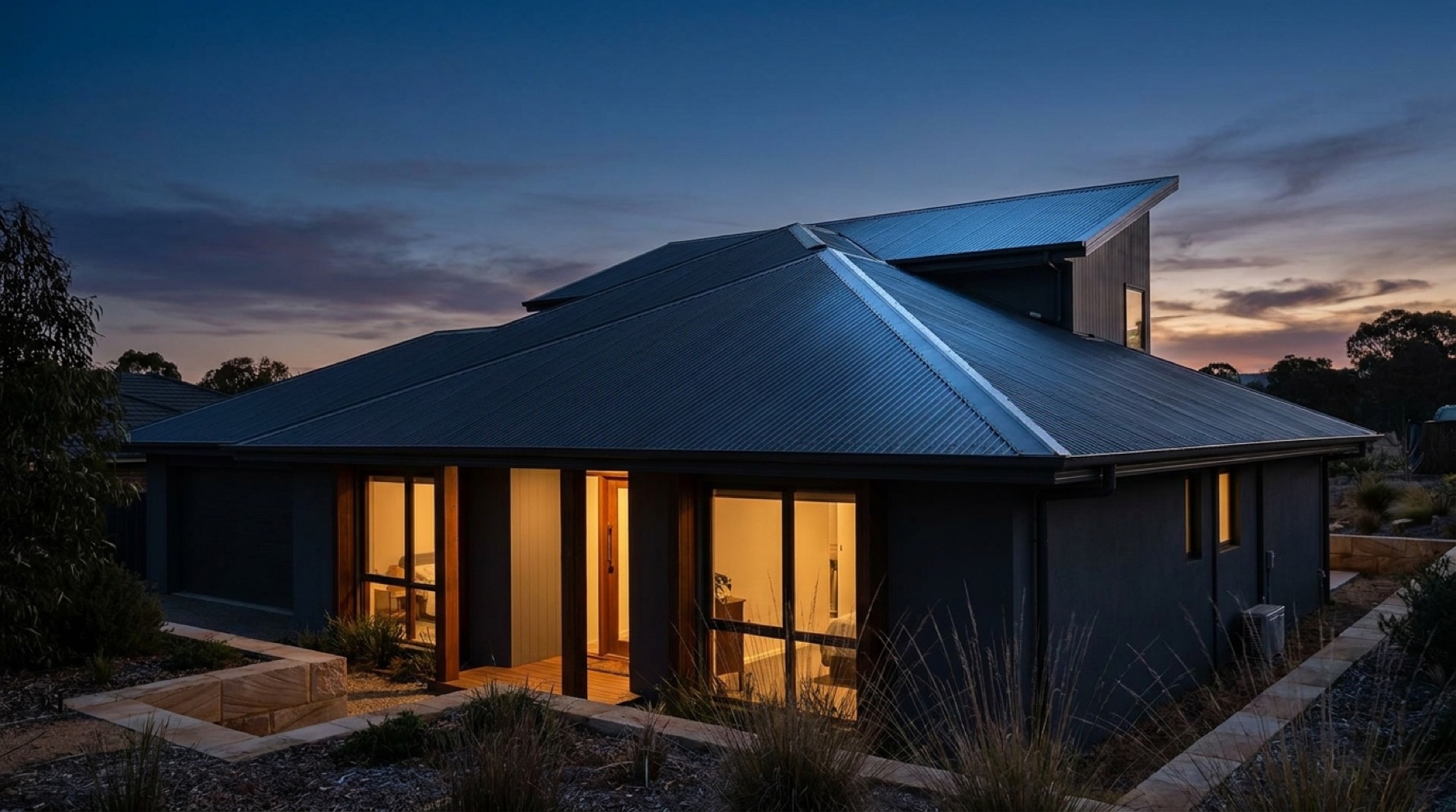 A home with a dark metal roof at dusk