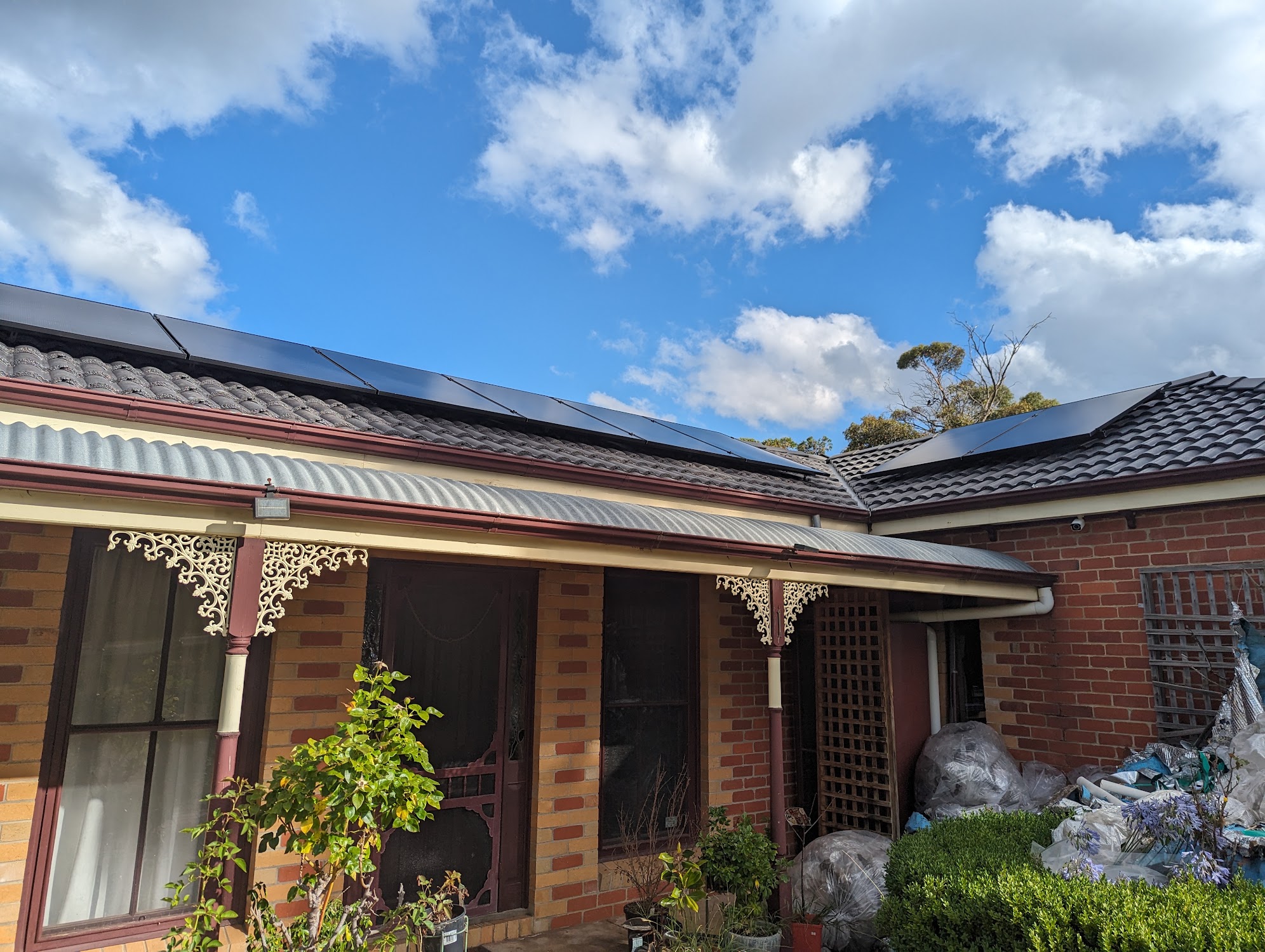 A brick verandah home with a new dark tile roof and solar panels