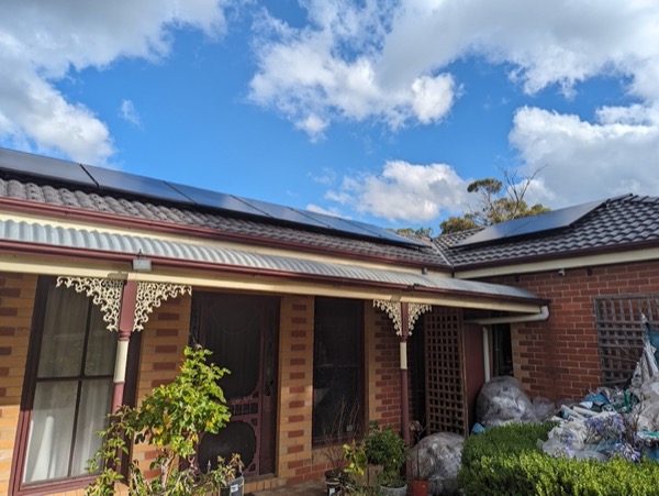 A brick verandah home with a new dark tile roof and solar panels