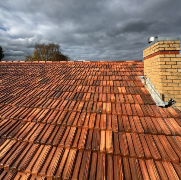 Close-up of weathered orange terracotta roof tiles