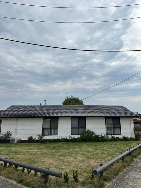 A weatherboard home with a newly finished roof seen from the street