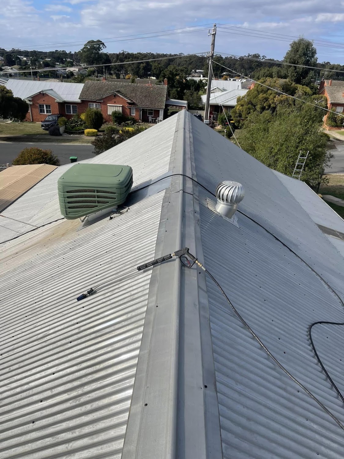 A Colorbond ridge line with a whirlybird and vent fitted